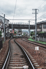 Fototapeta premium Curved Railway Tracks in a Quiet Japanese Neighborhood