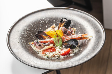 A gourmet seafood risotto with shrimp, mussels, squid, parmesan, and fresh herbs, elegantly plated...