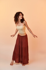 Charming young woman in stylish summer outfit posing gracefully in a light atmosphere