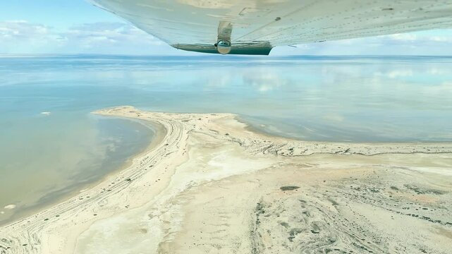 Witness the rare phenomenon of Lake Eyre in South Australia, observed from a Cessna aircraft. This unique aerial perspective captures the vast, arid landscape as it transforms with incoming water.