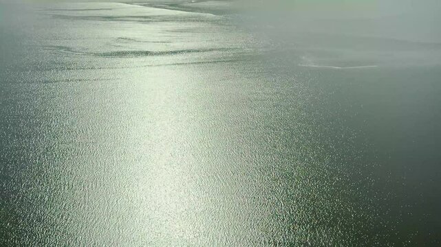 Stunning aerial view of Lake Eyre, revealing its rare and beautiful filling with water. Witness the unique natural phenomenon of the Australian outback from above, showcasing vast, shimmering water.
