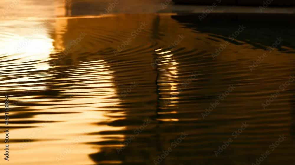 Poster a fluid abstract golden background with soft reflections and ripple motion