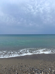 calm, crystal-clear sea under a bright blue sky. Gentle waves and serene water create a peaceful atmosphere, perfect for travel, relaxation, nature, and wellness projects