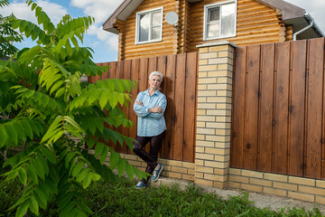 A Serene and Relaxing Garden Scene Featuring a Woman Posed Gracefully Against a Wooden Fence