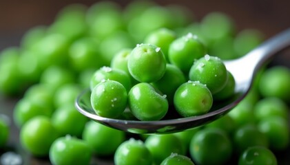 Macro shot of frozen peas on a stainless steel spoon, ingredient, cooking