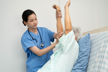 Asian doctor checking and treat elderly woman patient health in hospital.