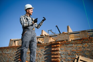 Construction worker in uniform and safety equipment have job on building