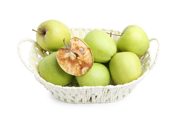 Spoiled apple and good ones in basket isolated on white
