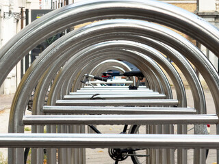 Symmetrical rows of empty bicycle racks on urban street