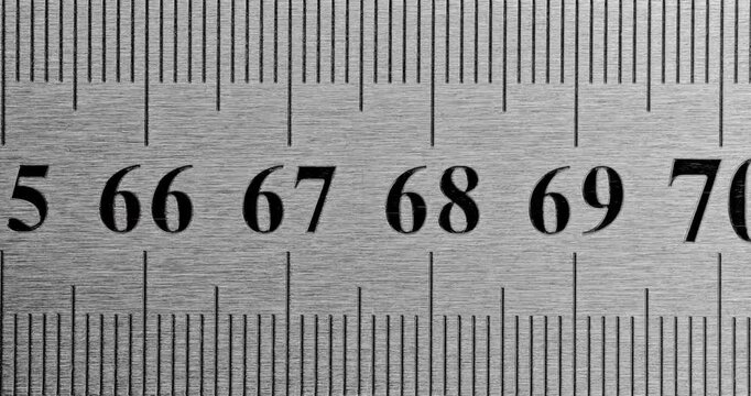 Metal Ruler Close-Up. Video featuring a detailed view of a sleek metal ruler with precise millimeter markings, captured in high clarity.
