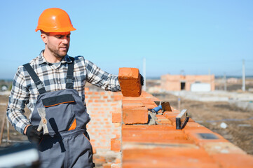 Construction worker in uniform and safety equipment have job on building