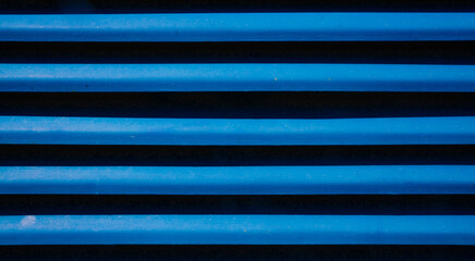 Close-up of blue metal horizontal louvered panels