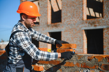 Construction worker in uniform and safety equipment have job on building