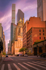 New York City street landscape with high-rise buildings and cars in Upper Manhattan — a vintage-style photo at stormy sunrise on a deserted Sunday morning.