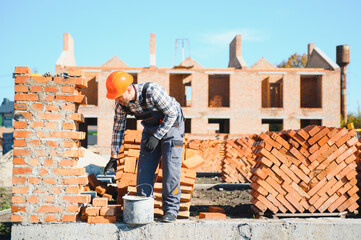 Construction worker in uniform and safety equipment have job on building
