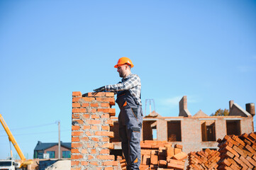 Construction worker in uniform and safety equipment have job on building