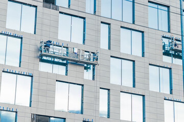 high rise working external wall of skyscraper building gray wall facade windows people occupation...