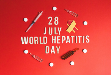 Stethoscope, pills tape, tools and the inscription World Hepatitis Day on red.