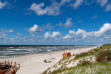 Curonian spit on a sunny summer day. Scenic view gray sand beach on the Baltic Sea coast in the village of Nida, Lithuania.