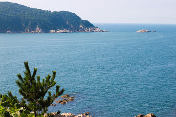 Scenic Coastal View Showcasing Serene Waters and Lush Green Hills in the Background, Perfect for...