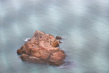 Scenic View of a Rocky Island Surrounded by Calm Waters Emphasizing Nature's Beauty and Tranquility...