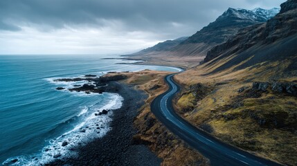 Majestic coastal road winds through rugged Icelandic landscape near ocean