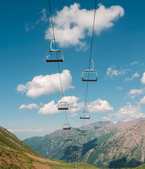 Open type ski lift in summer against the sky in the mountains