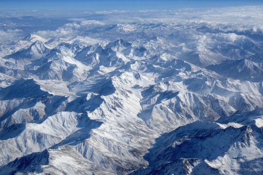 bird s eye view of snowy mountains from a plane