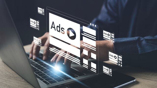 Person working on a laptop with multiple online advertisement banners displayed, representing internet marketing, digital ads, and media promotion strategy.