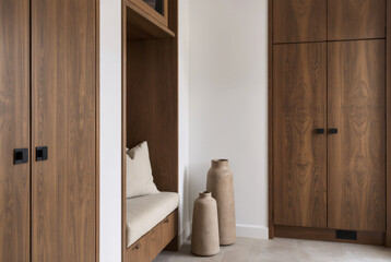 Minimalist Entryway with Built-in Oak Cabinets and Clay Vases