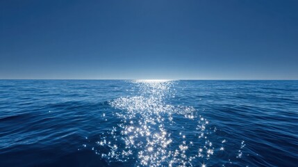 Fototapeta premium Vast ocean expanse under a clear sky. Sunlight sparkles on the water's surface