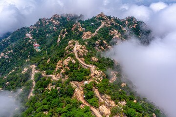 Mountain ridge winding path through clouds