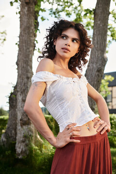 Fototapeta Stylish young woman exudes confidence in beautiful summer attire amidst natures backdrop
