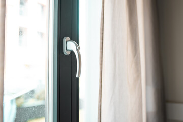 Woman opens a glass door or window handle with security lock button.