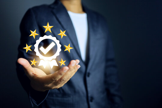 certificate concept with businessman holding the certified mark and star represent to that has certified to a quality standard and passed the audit according to industry compliance requirements