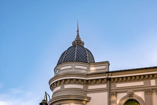 A golden-hour close-up of a historical dome. Shadows play across the detailed cornices and curved architecture. Use  for luxury real estate and architectural firm branding.
