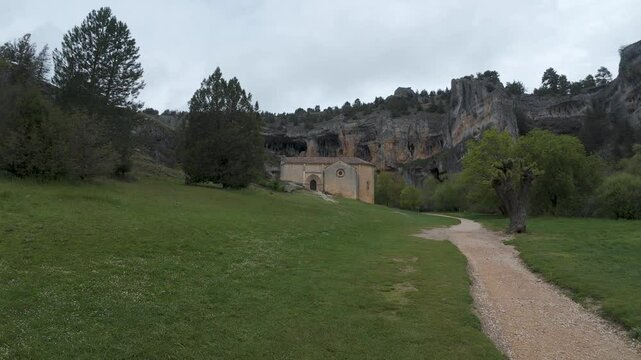 Olleros de pisuerga hermitage nestled in a natural rocky amphitheater