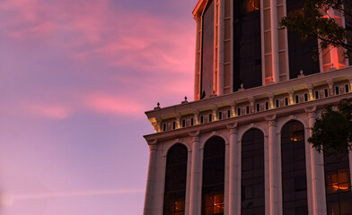 Close-up view of a modern building's architectural details against a stunning dusk sky. Blend of contemporary design with the soft colors of twilight.