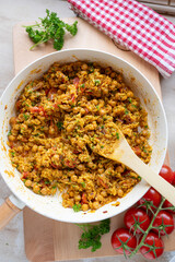 Chickpea curry with rice and vegetables fresh and homemade cooked in a frying pan on decorated background