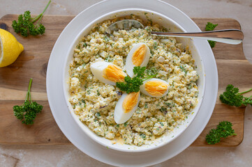 High protein and healthy egg salad with cottage cheese, boiled eggs, and herbs in a bowl