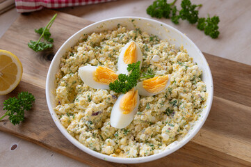 High protein and healthy egg salad with cottage cheese, boiled eggs, and herbs in a bowl