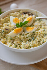 High protein and healthy egg salad with cottage cheese, boiled eggs, and herbs in a bowl