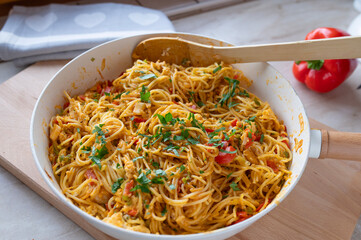 Pan Fried noodles with eggs and vegetables in a frying pan fresh and homemade cooked, 