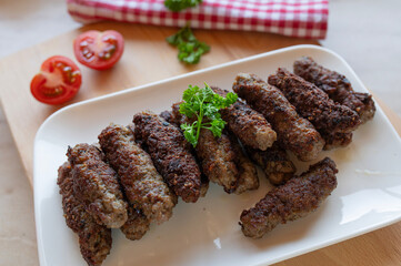 Delicious mititei or rumanian cevapcici on a plate fresh and homemade cooked