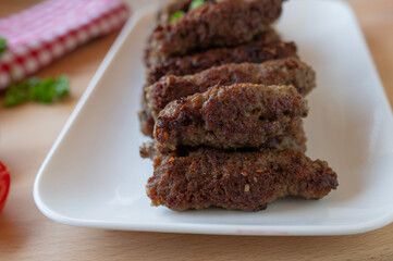 Delicious mititei or rumanian cevapcici on a plate fresh and homemade cooked
