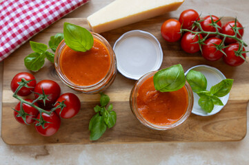 Tomato soup fresh and homemade cooked in a glass jar with ingredients