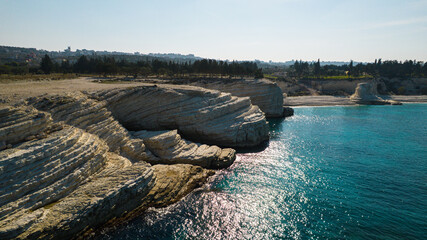 Aerial view of white rocky coastline in Syria. Rocks on coast beautiful sea bay at Latakia beach. Natural landscapes by the sea.