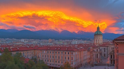 City skyline at sunset, dramatic clouds over mountain range