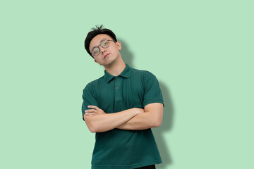 Casual Portrait of a Young Man Wearing Glasses in Green Polo Shirt
