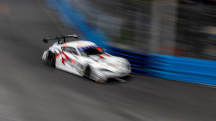 Motion blur race car racing on speed track, Motion blurred super car race on street track circuit,...